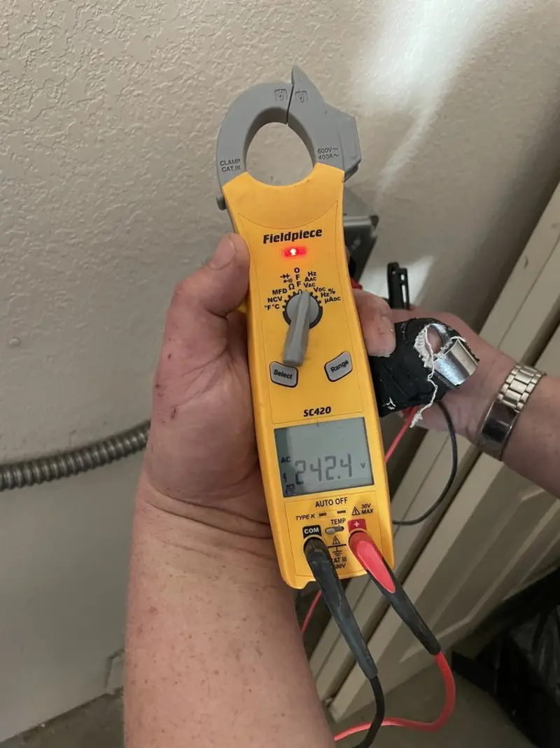 Voltage testing with clamp meter during Outlet Installation in Buena